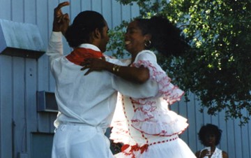 Photo of Neri Torres dancing with a man at a Cuban festival